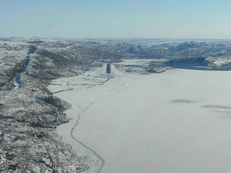 Approach to Kangerlussuaq, Greenland, along a frozen fjord, with the runway at its end